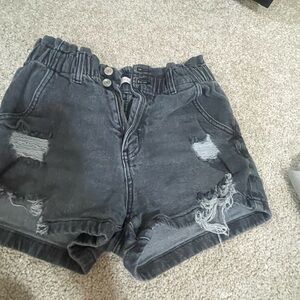 Black ripped shorts are high rise